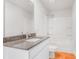 Bright bathroom with wood-look tile floor, white vanity and shower/tub combo at 271 Orwell Dr, Social Circle, GA 30025