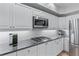 This bright kitchen features stainless appliances, gas range, white cabinetry, and granite countertops at 3636 Habersham Nw Rd # 2101, Atlanta, GA 30305