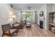 Cozy living room featuring wood floors, a fireplace, and a large window for natural light at 3636 Habersham Nw Rd # 2101, Atlanta, GA 30305