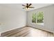 Bedroom with hardwood floors, ceiling fan and window with a view of trees at 479 Rising Sun Path, Lawrenceville, GA 30043