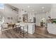 Open concept kitchen and living room with bar stool seating, high ceilings, and stainless appliances at 479 Rising Sun Path, Lawrenceville, GA 30043