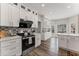 Well-lit kitchen featuring white cabinets, stainless steel appliances, and modern backsplash at 479 Rising Sun Path, Lawrenceville, GA 30043
