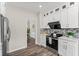 Updated kitchen with stainless steel appliances, subway tile backsplash, and white cabinetry at 479 Rising Sun Path, Lawrenceville, GA 30043
