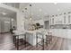Bright kitchen with large island, white cabinetry, stainless appliances, and modern pendant lighting at 479 Rising Sun Path, Lawrenceville, GA 30043