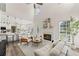 Open-concept living room with a fireplace and seamless flow to the modern kitchen at 479 Rising Sun Path, Lawrenceville, GA 30043