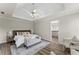 Spacious primary bedroom with tray ceilings and ensuite bathroom at 479 Rising Sun Path, Lawrenceville, GA 30043