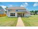 Beautiful backyard featuring a well-maintained lawn and a covered patio, ideal for outdoor living at 774 Phil Haven Ln, Kennesaw, GA 30152