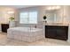 A bright primary bathroom with a tub, granite counters, and lots of natural light at 774 Phil Haven Ln, Kennesaw, GA 30152