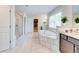 Bright primary bathroom featuring a glass shower, soaking tub, and dual vanities at 774 Phil Haven Ln, Kennesaw, GA 30152