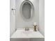 Half bath featuring a vanity with a brushed nickel faucet and decorative mirror at 774 Phil Haven Ln, Kennesaw, GA 30152
