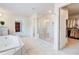 Primary bathroom featuring a glass shower, walk in closet, and soaking tub at 774 Phil Haven Ln, Kennesaw, GA 30152