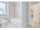 Bathroom featuring tiled shower, a toilet, and a doorway looking into the bedroom at 774 Phil Haven Ln, Kennesaw, GA 30152