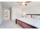 Bedroom features a ceiling fan, carpeted floor, and views into the Primary bathroom and closet at 774 Phil Haven Ln, Kennesaw, GA 30152