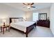 Cozy bedroom featuring a ceiling fan, carpeted floor, a window, and dark wood furniture at 774 Phil Haven Ln, Kennesaw, GA 30152