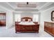 Bedroom featuring a tray ceiling, neutral paint, carpeted floors, and lots of light at 774 Phil Haven Ln, Kennesaw, GA 30152