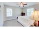Comfortable bedroom with neutral carpet, two windows and ceiling fan at 774 Phil Haven Ln, Kennesaw, GA 30152