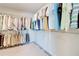 A large walk-in closet with plenty of space for storage including shelves and hanger racks at 774 Phil Haven Ln, Kennesaw, GA 30152