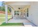 Inviting covered patio with ceiling fan and outdoor dining set, perfect for entertaining or relaxation at 774 Phil Haven Ln, Kennesaw, GA 30152