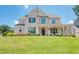 Charming two-story brick home with a manicured lawn and inviting front porch with hanging lanterns at 774 Phil Haven Ln, Kennesaw, GA 30152