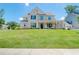 Charming two-story brick home with a manicured lawn and inviting front porch and an attached garage at 774 Phil Haven Ln, Kennesaw, GA 30152