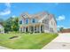 Charming two-story brick home with a manicured lawn and inviting front porch with hanging lanterns at 774 Phil Haven Ln, Kennesaw, GA 30152