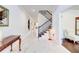 Elegant foyer with marble tile flooring, staircase with iron railing, and neutral wall color at 774 Phil Haven Ln, Kennesaw, GA 30152