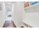 Hallway with hardwood floors, coat hooks, and view into kitchen at 774 Phil Haven Ln, Kennesaw, GA 30152