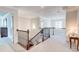 Spacious second floor hallway with decorative wrought iron railing and plush carpeting at 774 Phil Haven Ln, Kennesaw, GA 30152