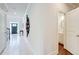 Hallway with marble tile leading to front door, view into bathroom, and dark hardwood floors at 774 Phil Haven Ln, Kennesaw, GA 30152