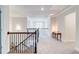 Spacious second floor hallway with decorative wrought iron railing and plush carpeting at 774 Phil Haven Ln, Kennesaw, GA 30152