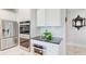 Modern kitchen features stainless appliances, a double oven and bright white cabinets at 774 Phil Haven Ln, Kennesaw, GA 30152