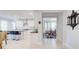 Kitchen with white cabinets and backsplash open to a dining and living area at 774 Phil Haven Ln, Kennesaw, GA 30152