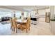 Bright open-concept kitchen and dining area with stainless steel appliances and island with bar seating at 774 Phil Haven Ln, Kennesaw, GA 30152