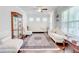 Bright living room featuring hardwood floors, elegant furnishings, and large windows with natural light at 774 Phil Haven Ln, Kennesaw, GA 30152
