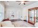 Bright living room featuring hardwood floors, elegant furnishings, and French doors to another room at 774 Phil Haven Ln, Kennesaw, GA 30152