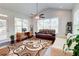 Sun-filled living room features an airy vaulted ceiling, a ceiling fan, and gleaming hardwood floors at 774 Phil Haven Ln, Kennesaw, GA 30152