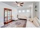 Bright living room featuring hardwood floors, elegant furnishings, a ceiling fan and large windows with natural light at 774 Phil Haven Ln, Kennesaw, GA 30152