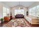 Sun-filled living room features an airy vaulted ceiling, a ceiling fan, and gleaming hardwood floors at 774 Phil Haven Ln, Kennesaw, GA 30152