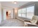 Bright sitting area with plush armchair next to large windows and a doorway to the bathroom at 774 Phil Haven Ln, Kennesaw, GA 30152