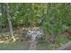 Secluded backyard featuring an octagonal deck in a beautifully landscaped setting, surrounded by mature trees at 840 Milton Oaks Dr, Johns Creek, GA 30022