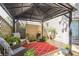 Covered backyard patio with comfortable seating and a view of the yard at 840 Milton Oaks Dr, Johns Creek, GA 30022