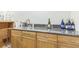 A nice wet bar with wood cabinets and stone countertop at 840 Milton Oaks Dr, Johns Creek, GA 30022