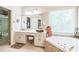 Bright bathroom with a whirlpool tub, vanity, and lots of natural light at 840 Milton Oaks Dr, Johns Creek, GA 30022