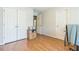 Bedroom with wood floors, closet space, and a neutral color scheme at 840 Milton Oaks Dr, Johns Creek, GA 30022