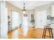 Cozy breakfast nook featuring hardwood floors, large windows, and elegant light fixture at 840 Milton Oaks Dr, Johns Creek, GA 30022