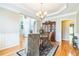 Well-lit dining room with hardwood floors, chandelier, and easy access to other rooms in the home at 840 Milton Oaks Dr, Johns Creek, GA 30022