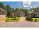 Beautiful brick home with a well-manicured lawn and a three-car garage at 840 Milton Oaks Dr, Johns Creek, GA 30022