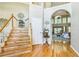 Bright foyer with hardwood floors, staircase, and a view into the living room with large windows at 840 Milton Oaks Dr, Johns Creek, GA 30022