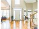 Open foyer with hardwood floors, staircase, and large windows providing lots of natural light at 840 Milton Oaks Dr, Johns Creek, GA 30022