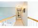 Upstairs hallway with neutral carpet, light paint and lots of wall decor at 840 Milton Oaks Dr, Johns Creek, GA 30022